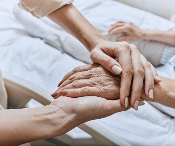 Family comforting senior patient.